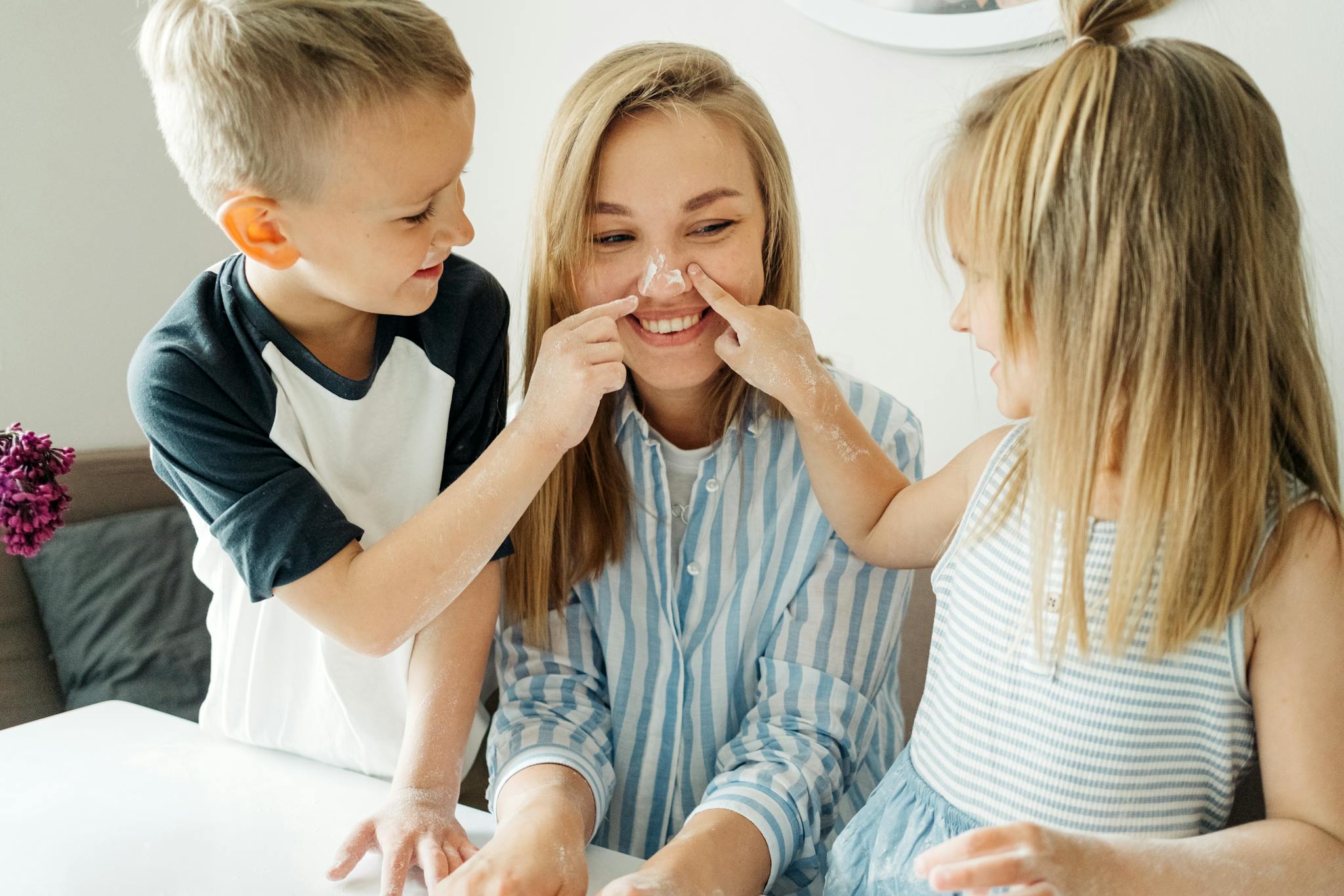 A joyful family moment with children baking and playing at home.